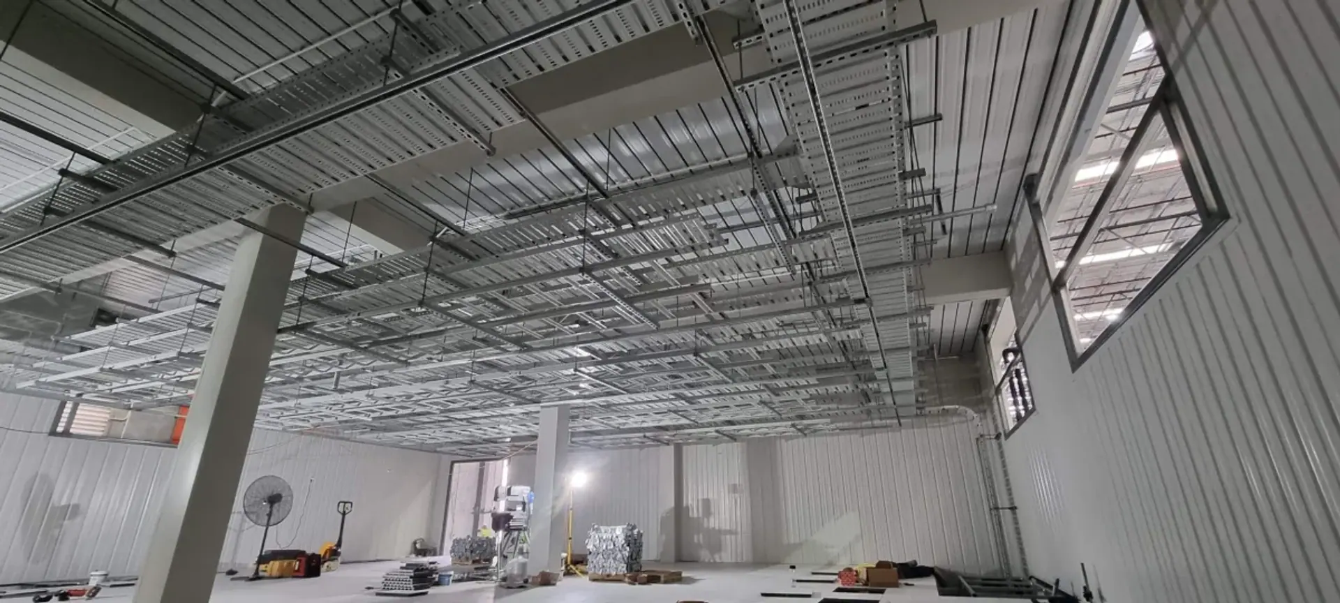 Overhead electrical cable trays and cabling in a commercial installation from Bannan’s portfolio