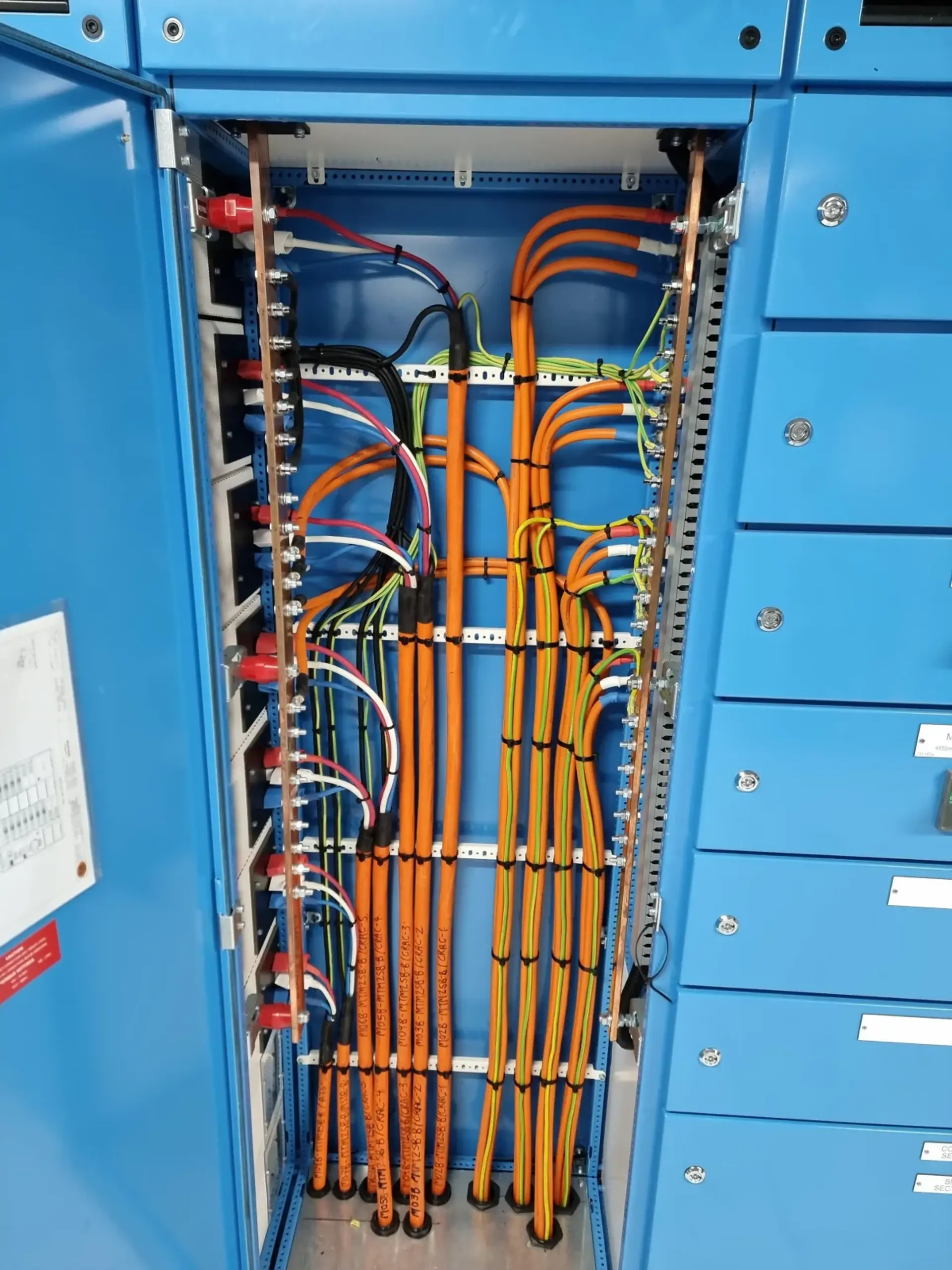 Detailed electrical wiring inside a blue commercial switchboard